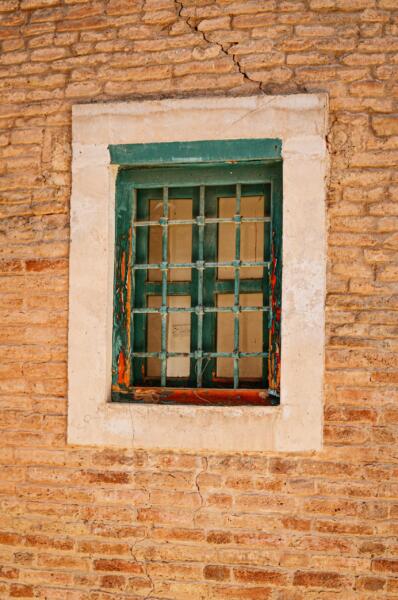 Window of an old property with cracks and subsidence