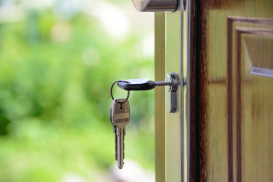 Key in the lock of a house door of a residential landlord