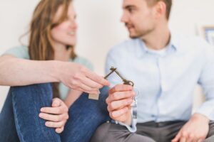 Couple holding keys to their house | Selling your home